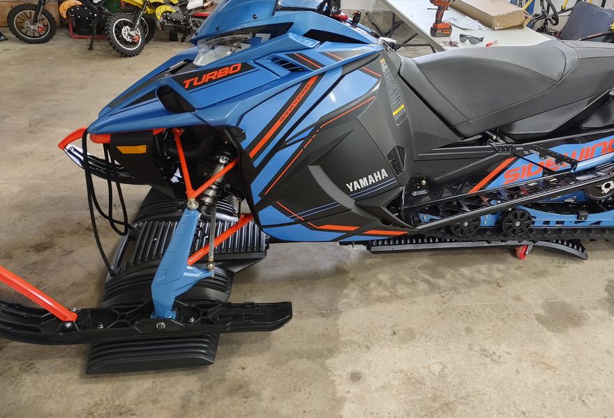 snowmobile on a SledEZ dolly in a garage