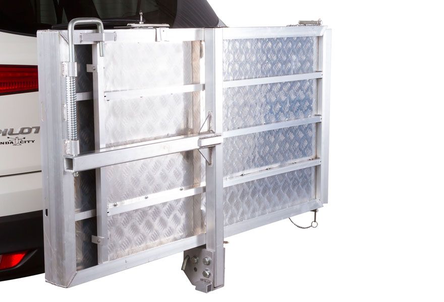 Carrier folds up against vehicle when not in use 