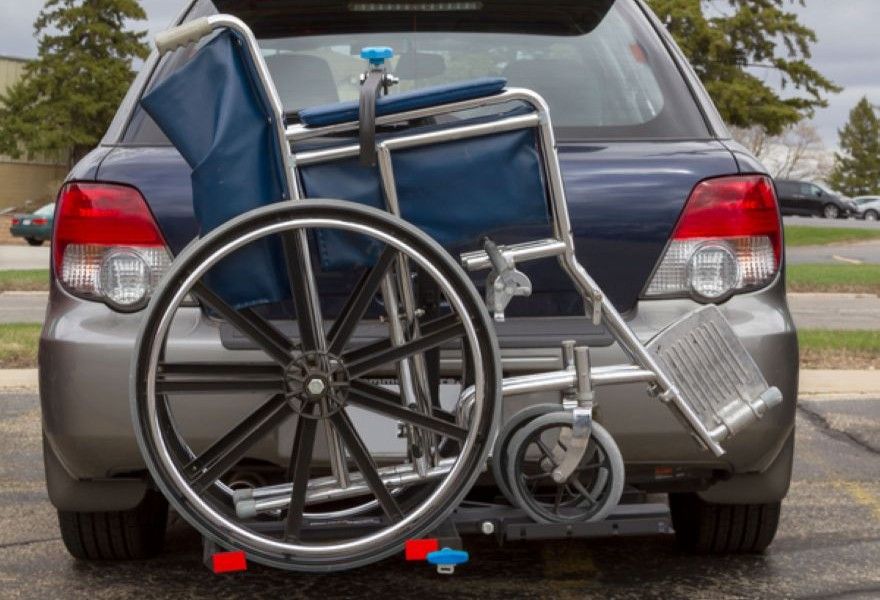 manual wheelchair loaded on rear-mounted carrier