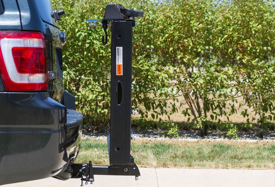 Carrier folds up against vehicle when not in use 