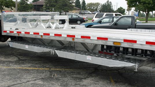Transport ramps securely under flatbed or step deck trailers