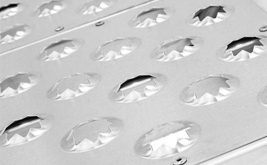 Non-slip grip with EZ Traction punch plate surface