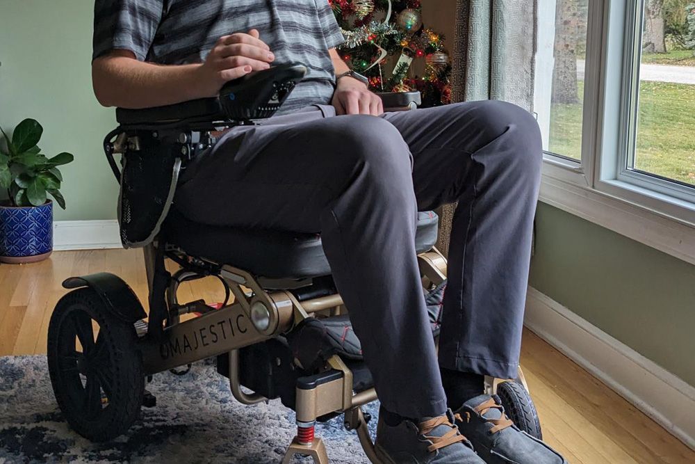 man in electric wheelchair inside home at christmas