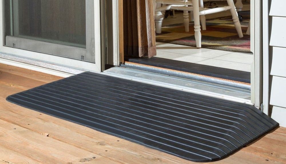 Rubber threshold ramp bridging doorway lip