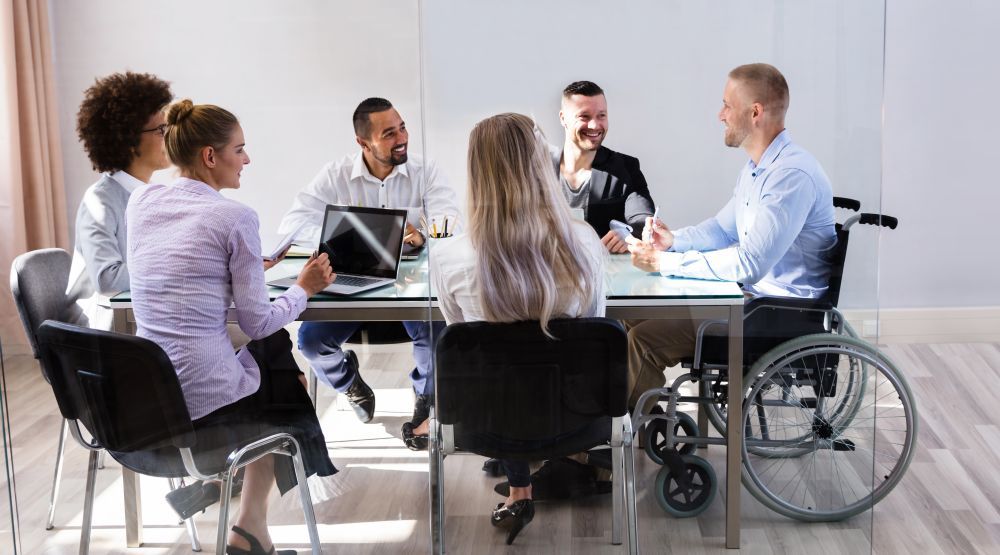 A group of coworkers at a table having a conversation.