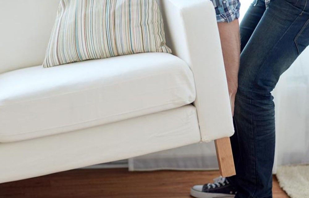 Photo of a person moving a couch