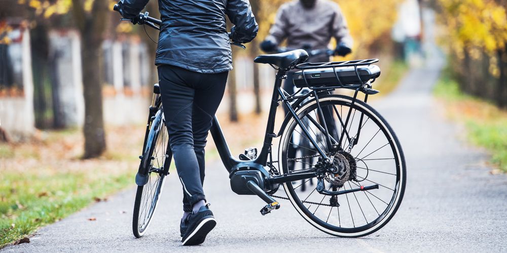 Two senior citizens enjoying their ebikes outside