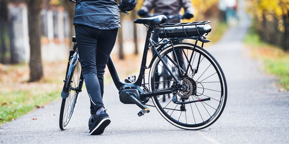Women riding an electric bicycle or ebike outdoors in the fall