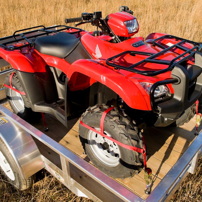 red ATV secured with wheel nets to a single ATV trailer