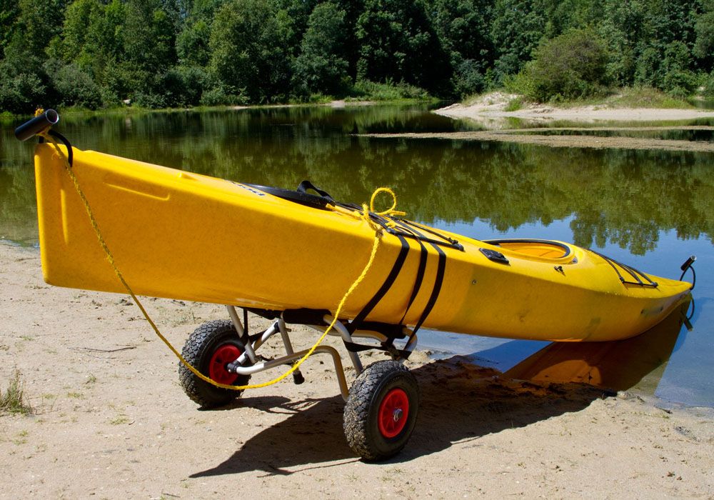 kayak secured to dolly at the edge of a lake
