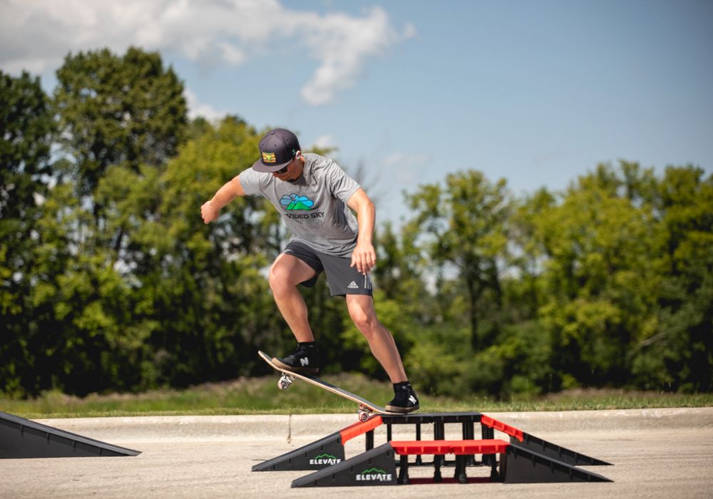 man riding skateboard ramp in skatepark