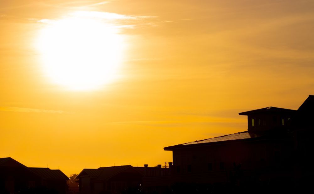Picture of a sun above houses