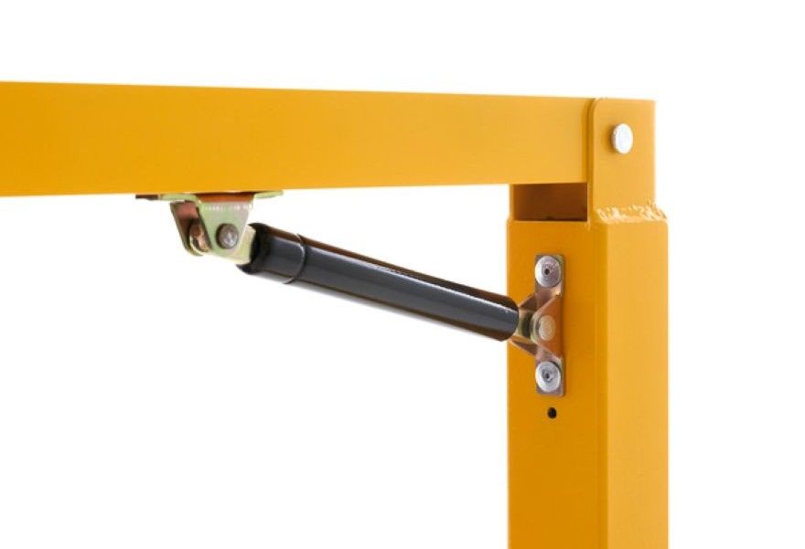 Close-up of gas strut attached to yellow dock safety gate