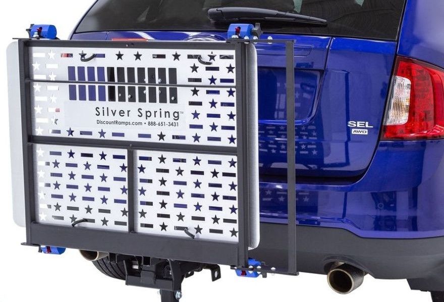 view of electric lift folded upright against vehicle
