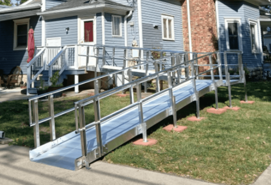 Textured aluminum wheelchair ramp with integrated handrails