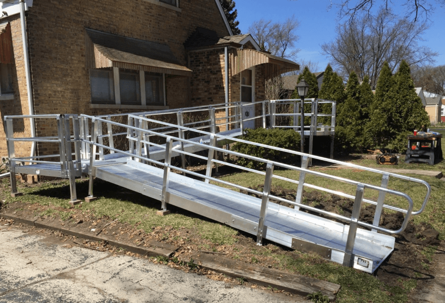 Textured aluminum wheelchair ramp with integrated handrails