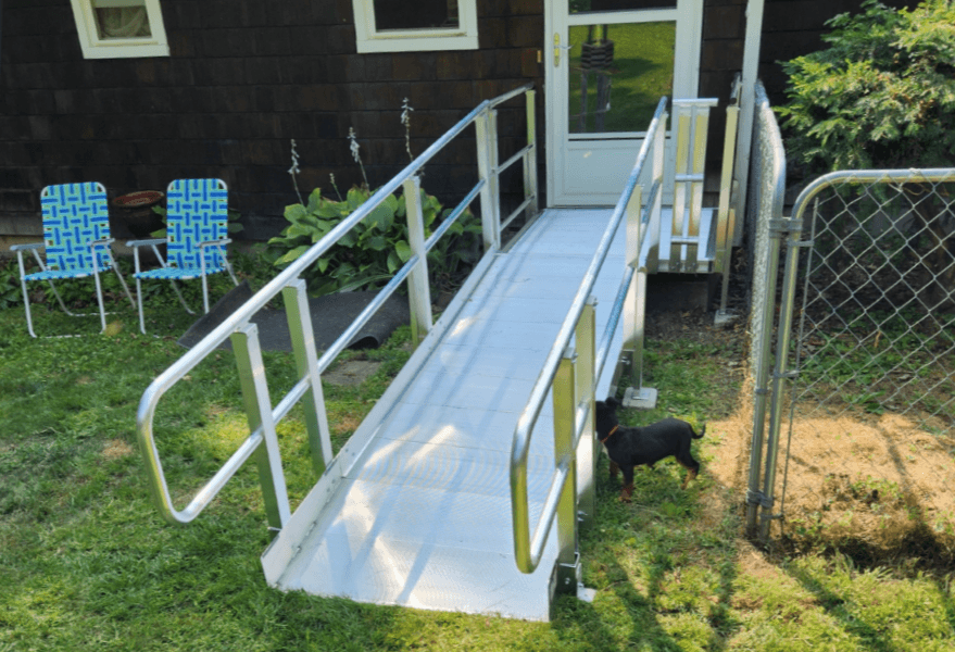 Textured aluminum wheelchair ramp with integrated handrails
