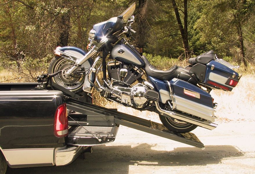 Motorcycle being loaded into a truck with the Rampage system