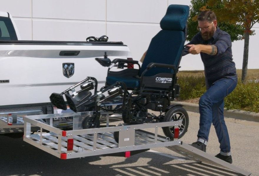 person installing lightweight aluminum mobility carrier