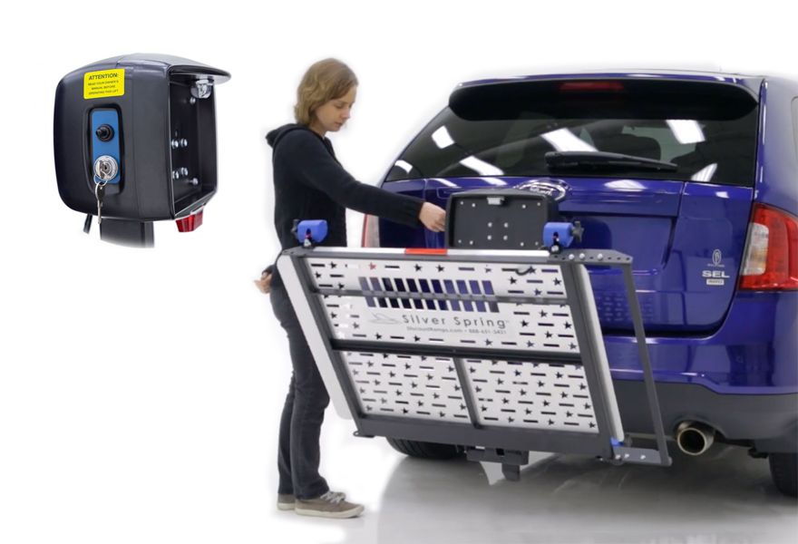 person operating electric scooter lift with mobility device loaded