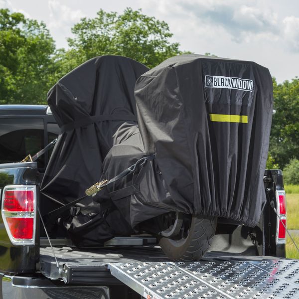 Black Widow transport cover over a motorcycle in a pickup truck trailer with a punch plate ramp